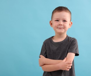 Photo of Portrait of smiling boy on light blue background