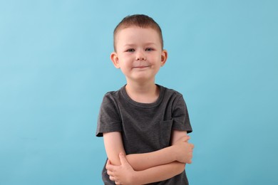 Photo of Portrait of smiling boy on light blue background
