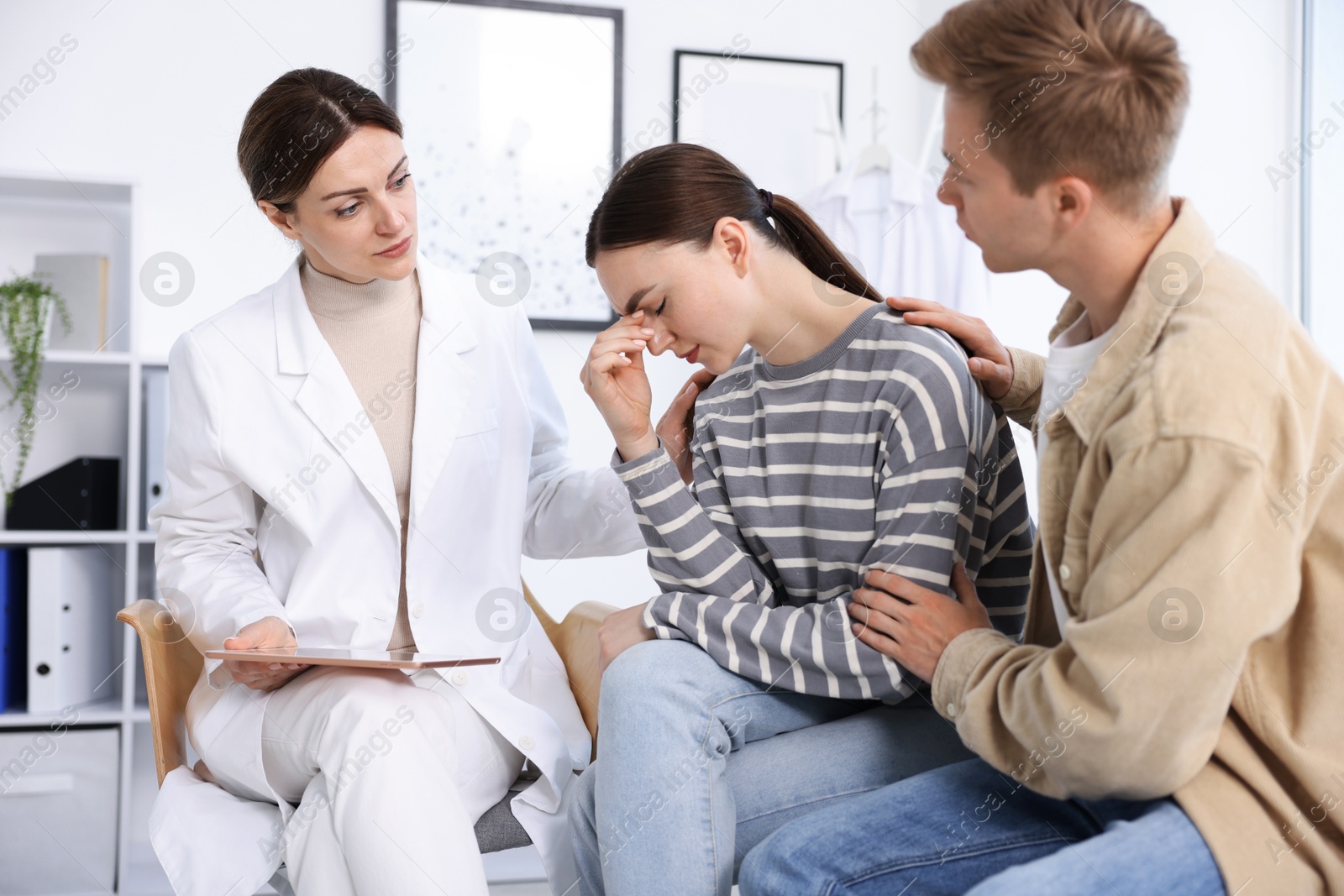 Photo of In vitro fertilization (IVF). Doctor supporting upset couple during visit in reproductive clinic