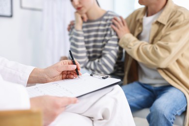Photo of In vitro fertilization (IVF). Couple having appointment with doctor in reproductive clinic, closeup