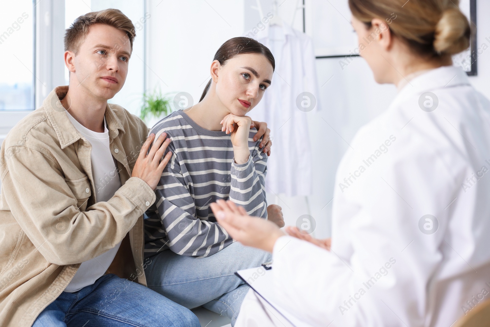In vitro fertilization (IVF). Couple having appointment with doctor in reproductive clinic Photo of In vitro fertilization (IVF). Couple having appointment with doctor in reproductive clinic