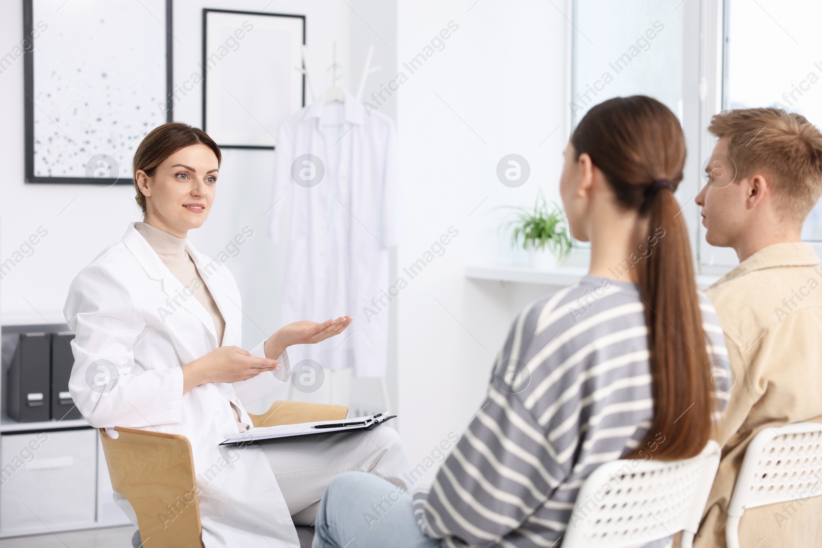 In vitro fertilization (IVF). Couple having appointment with doctor in reproductive clinic Photo of In vitro fertilization (IVF). Couple having appointment with doctor in reproductive clinic