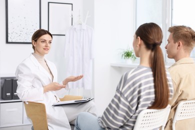 Photo of In vitro fertilization (IVF). Couple having appointment with doctor in reproductive clinic