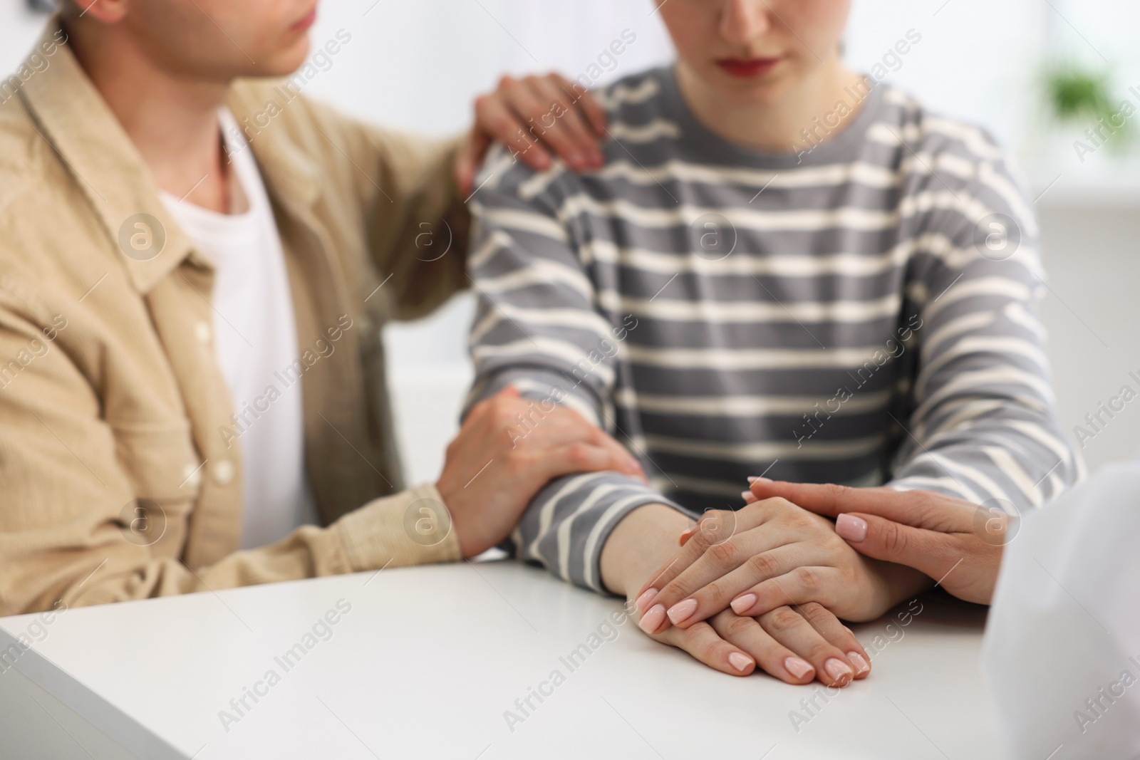 In vitro fertilization (IVF). Doctor supporting couple during visit in reproductive clinic, closeup Photo of In vitro fertilization (IVF). Doctor supporting couple during visit in reproductive clinic, closeup