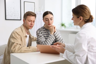 Photo of In vitro fertilization (IVF). Couple having appointment with doctor in reproductive clinic