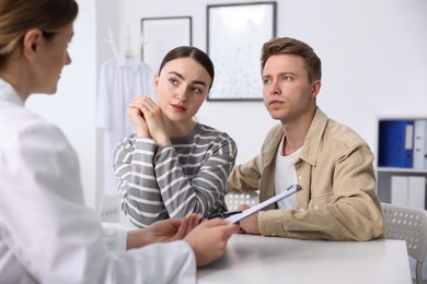 Photo of In vitro fertilization (IVF). Couple having appointment with doctor in reproductive clinic