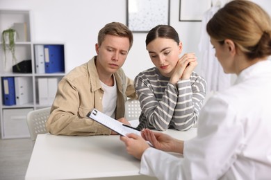 Photo of In vitro fertilization (IVF). Couple having appointment with doctor in reproductive clinic