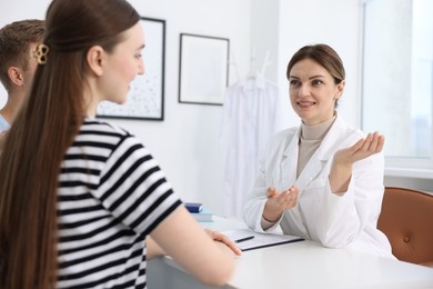 Photo of In vitro fertilization (IVF). Happy couple having appointment with doctor in reproductive clinic