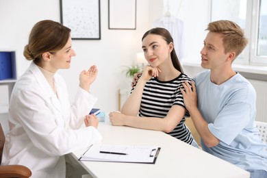 Photo of In vitro fertilization (IVF). Couple having appointment with doctor in reproductive clinic