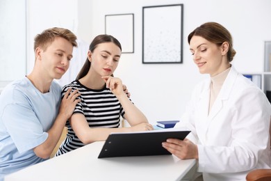 Photo of In vitro fertilization (IVF). Couple having appointment with doctor in reproductive clinic