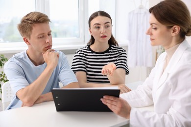 Photo of In vitro fertilization (IVF). Couple having appointment with doctor in reproductive clinic