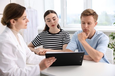 Photo of In vitro fertilization (IVF). Couple having appointment with doctor in reproductive clinic