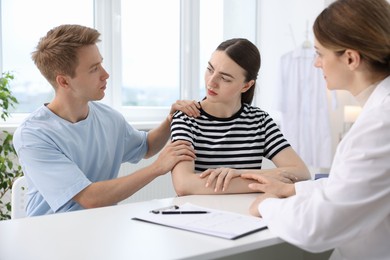 Photo of In vitro fertilization (IVF). Doctor supporting upset couple during visit in reproductive clinic