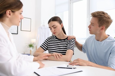 Photo of In vitro fertilization (IVF). Doctor supporting upset couple during visit in reproductive clinic