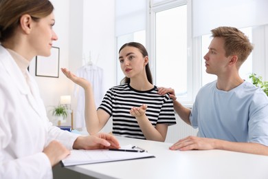 Photo of In vitro fertilization (IVF). Couple having appointment with doctor in reproductive clinic