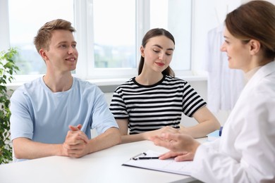Photo of In vitro fertilization (IVF). Couple having appointment with doctor in reproductive clinic