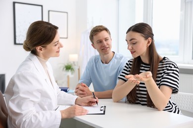Photo of In vitro fertilization (IVF). Couple having appointment with doctor in reproductive clinic