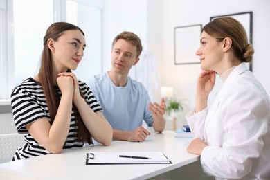 Photo of In vitro fertilization (IVF). Couple having appointment with doctor in reproductive clinic