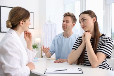 Photo of In vitro fertilization (IVF). Couple having appointment with doctor in reproductive clinic