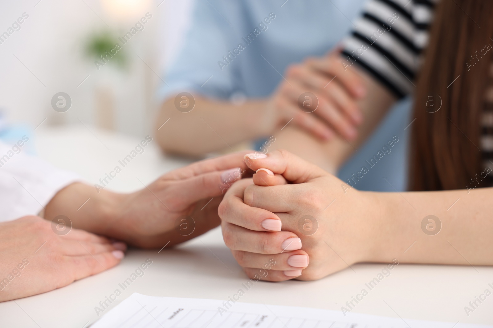 In vitro fertilization (IVF). Doctor encouraging couple during visit in reproductive clinic, closeup Photo of In vitro fertilization (IVF). Doctor encouraging couple during visit in reproductive clinic, closeup