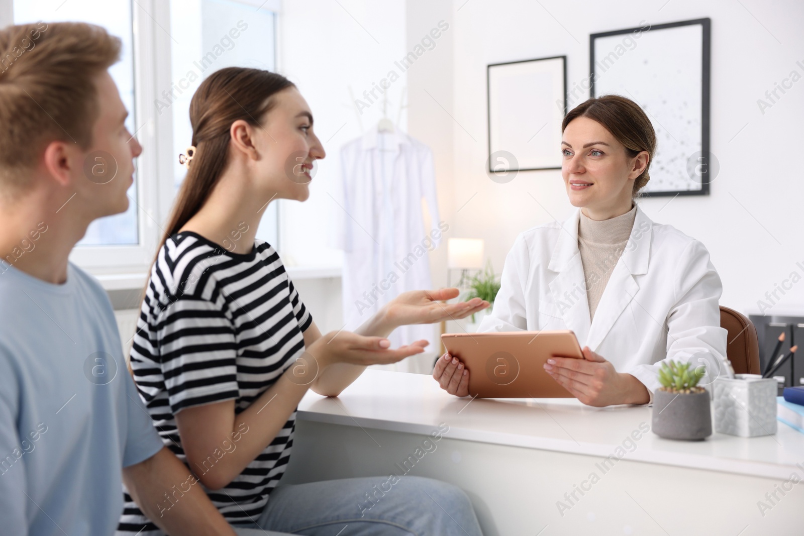 Photo of In vitro fertilization (IVF). Couple having appointment with doctor in reproductive clinic