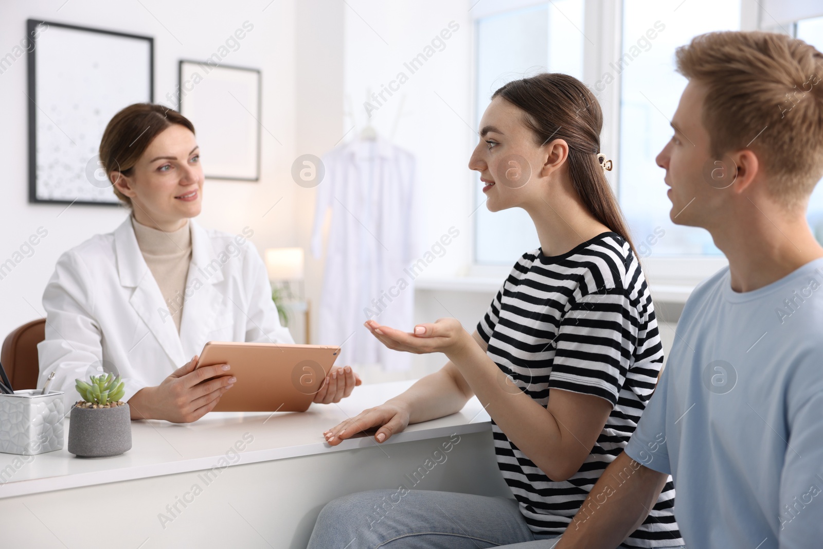 Photo of In vitro fertilization (IVF). Couple having appointment with doctor in reproductive clinic
