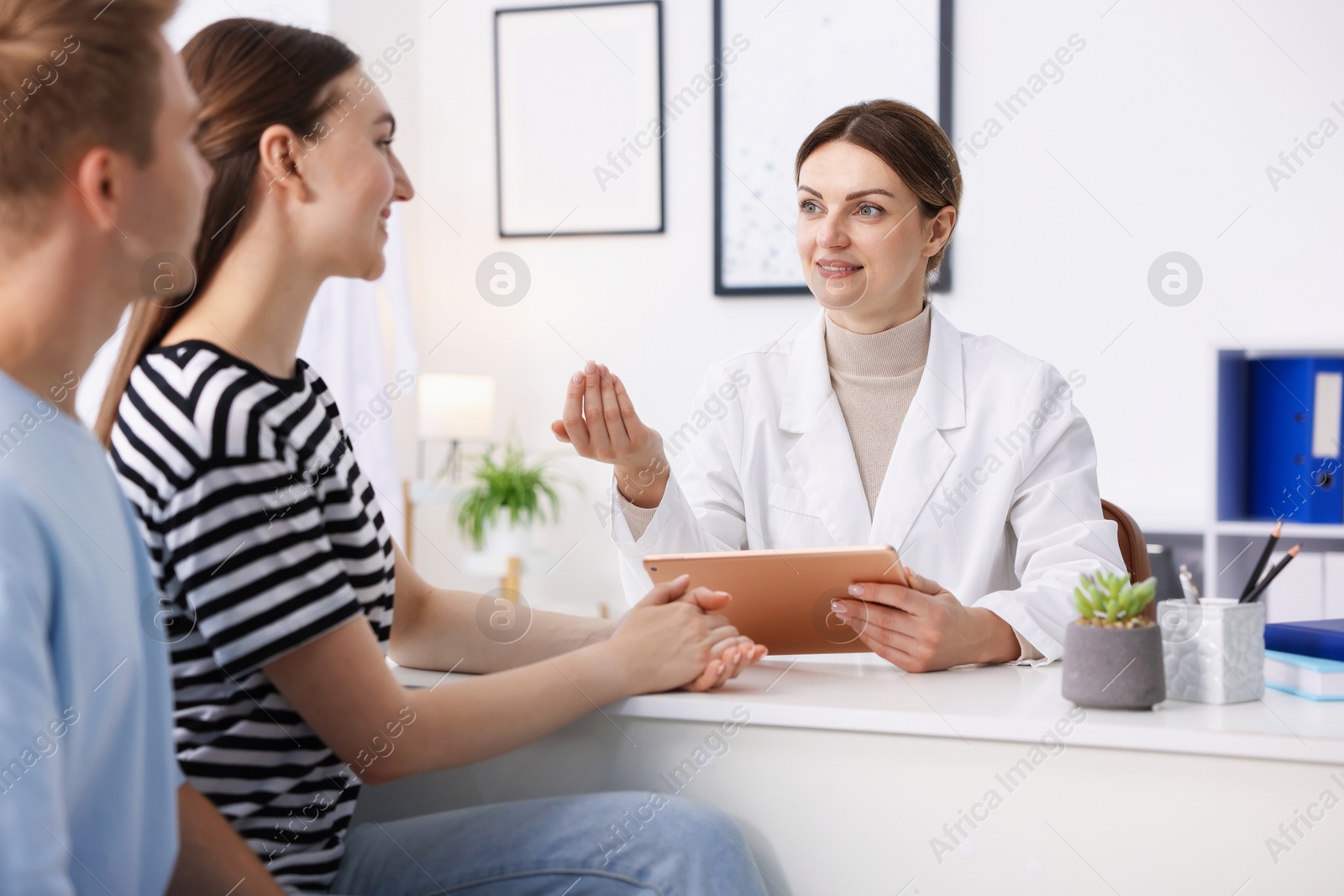 Photo of In vitro fertilization (IVF). Couple having appointment with doctor in reproductive clinic