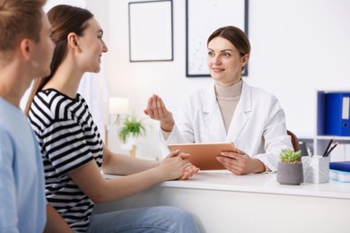Photo of In vitro fertilization (IVF). Couple having appointment with doctor in reproductive clinic