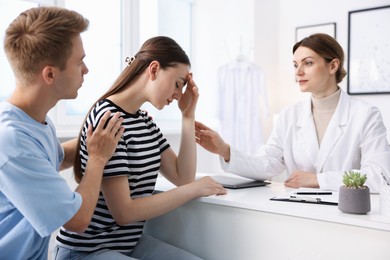 Photo of In vitro fertilization (IVF). Doctor supporting upset couple during visit in reproductive clinic