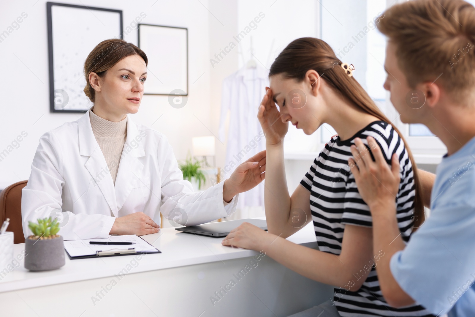 Photo of In vitro fertilization (IVF). Doctor supporting upset couple during visit in reproductive clinic