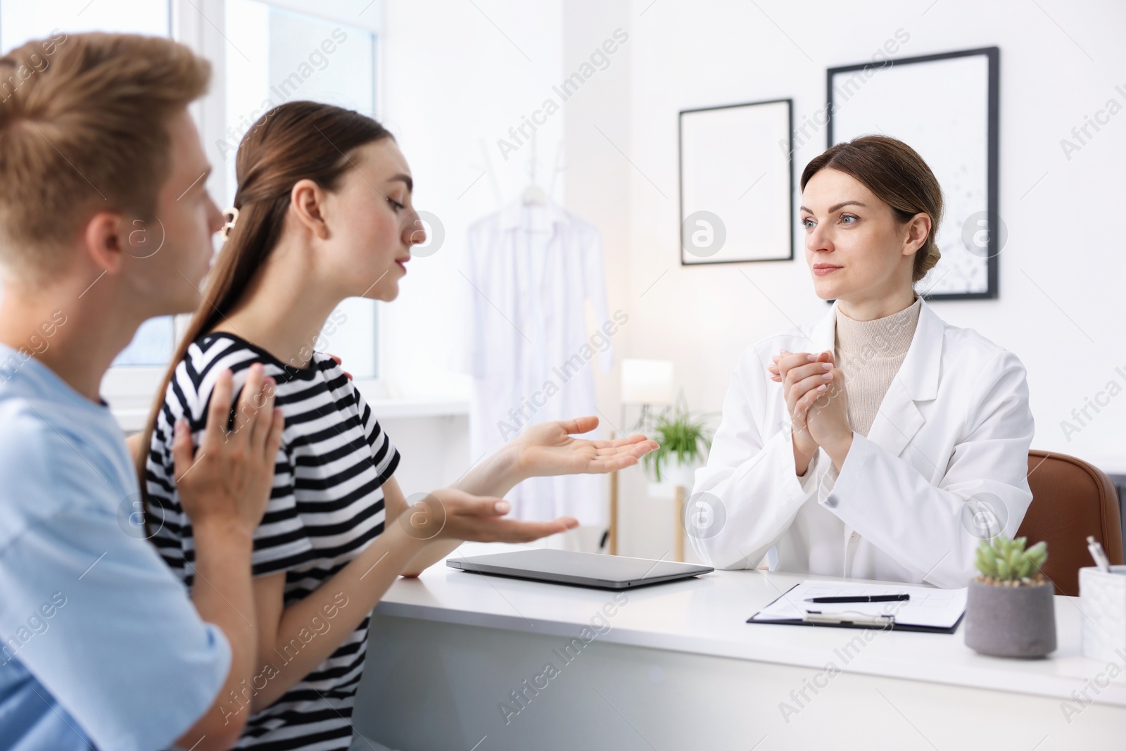 Photo of In vitro fertilization (IVF). Couple having appointment with doctor in reproductive clinic