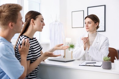 Photo of In vitro fertilization (IVF). Couple having appointment with doctor in reproductive clinic