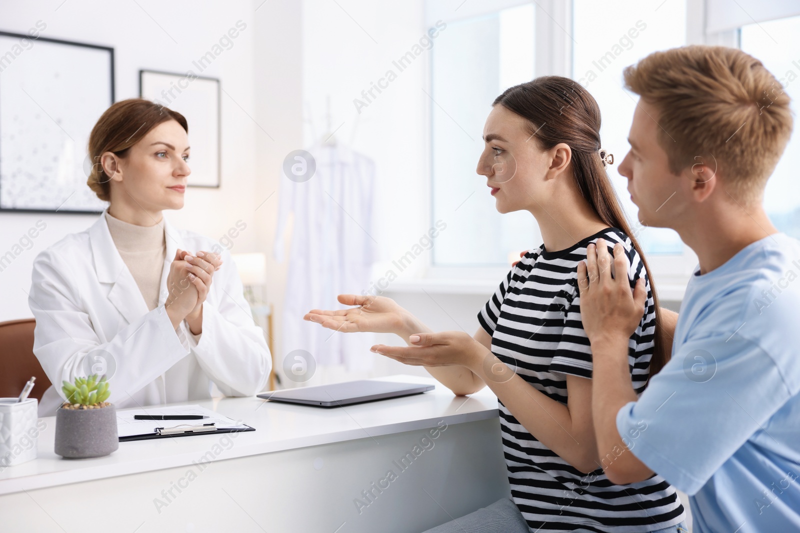 Photo of In vitro fertilization (IVF). Couple having appointment with doctor in reproductive clinic