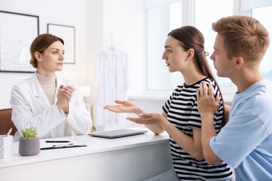 Photo of In vitro fertilization (IVF). Couple having appointment with doctor in reproductive clinic