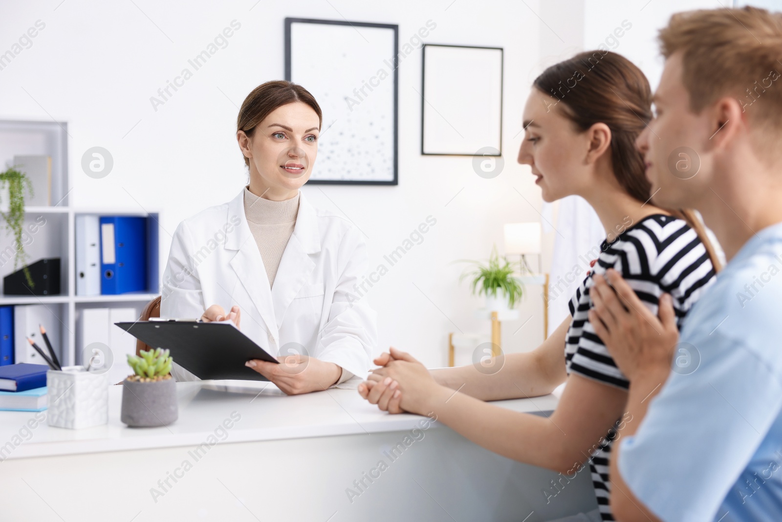Photo of In vitro fertilization (IVF). Couple having appointment with doctor in reproductive clinic
