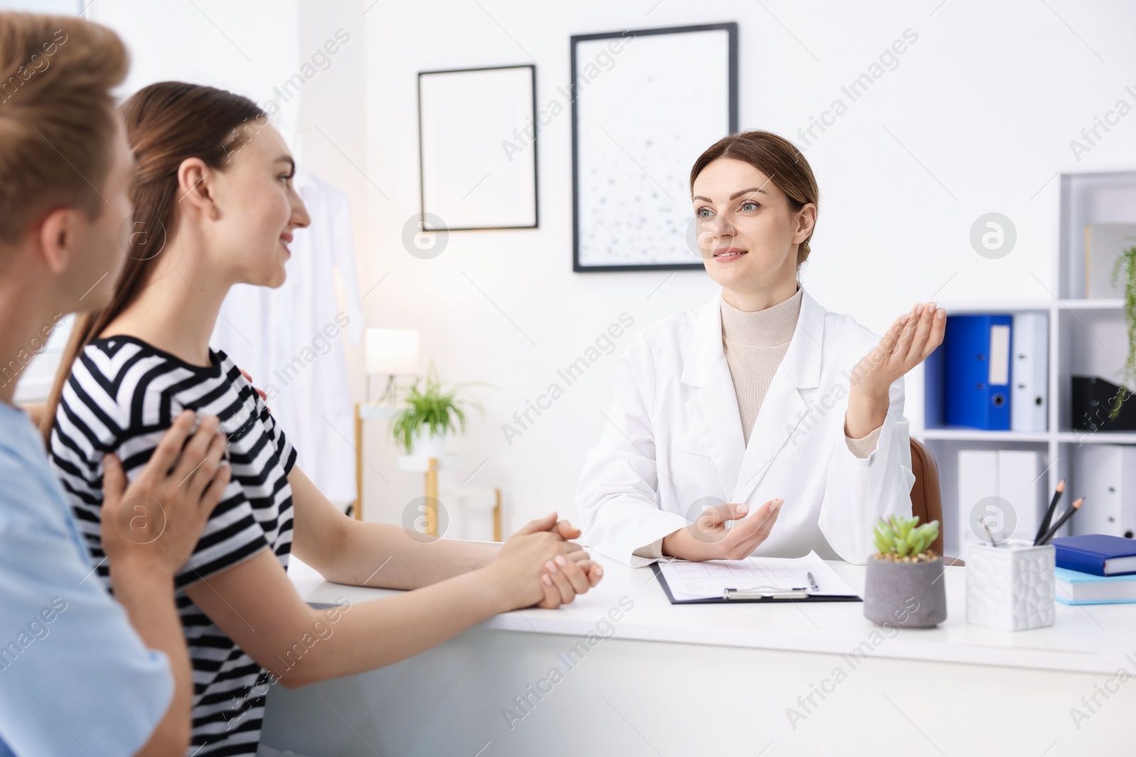 Photo of In vitro fertilization (IVF). Couple having appointment with doctor in reproductive clinic