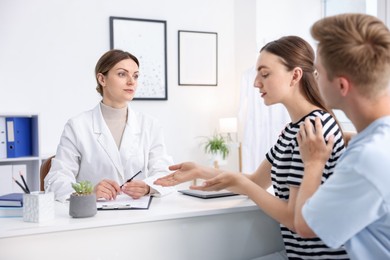 Photo of In vitro fertilization (IVF). Couple having appointment with doctor in reproductive clinic