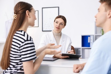 Photo of In vitro fertilization (IVF). Couple having appointment with doctor in reproductive clinic