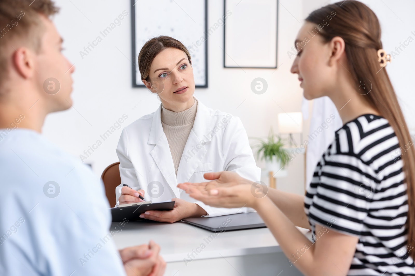 Photo of In vitro fertilization (IVF). Couple having appointment with doctor in reproductive clinic