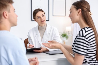 Photo of In vitro fertilization (IVF). Couple having appointment with doctor in reproductive clinic