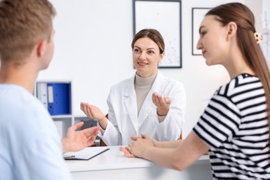 Photo of In vitro fertilization (IVF). Couple having appointment with doctor in reproductive clinic