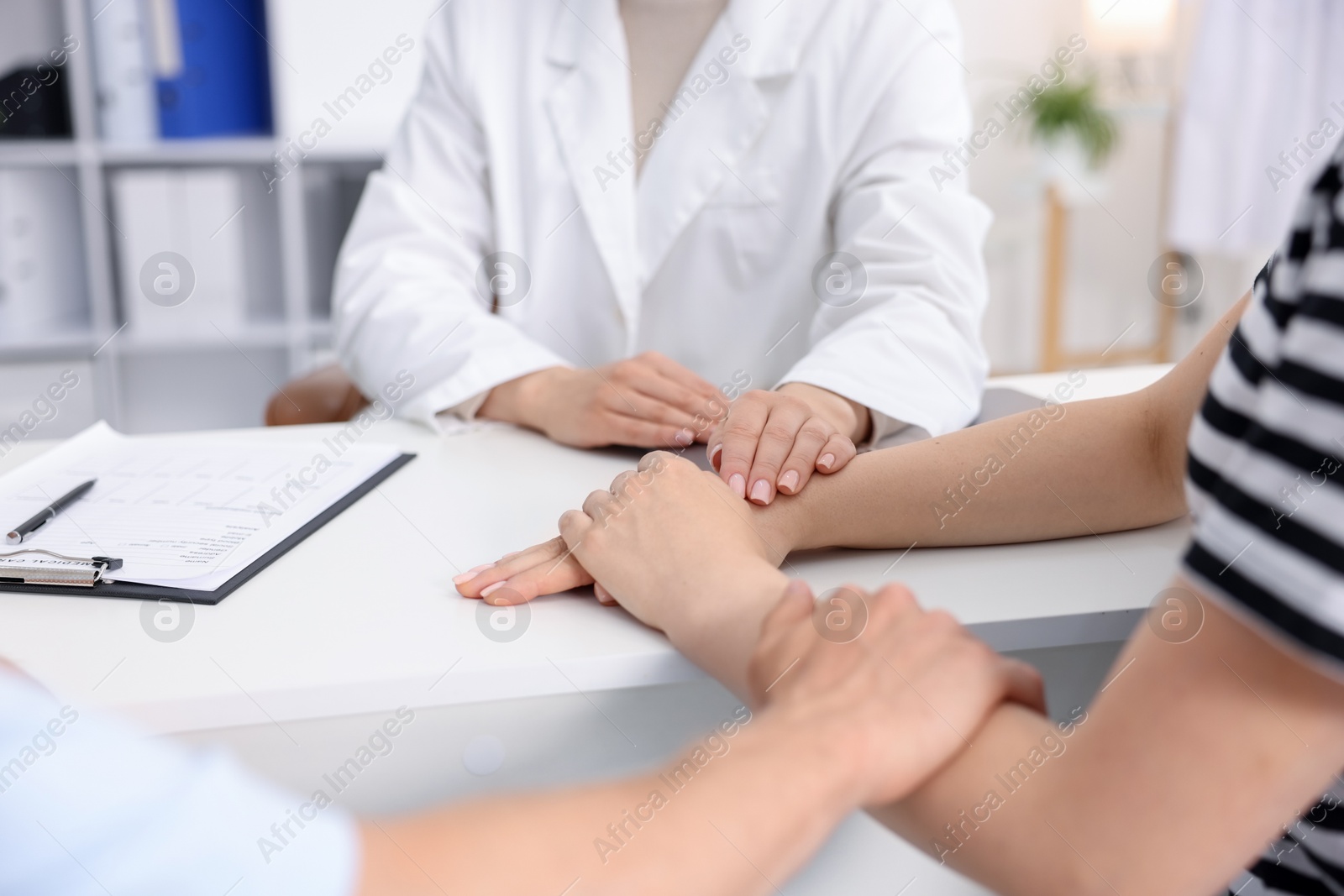 In vitro fertilization (IVF). Doctor encouraging couple during visit in reproductive clinic, closeup Photo of In vitro fertilization (IVF). Doctor encouraging couple during visit in reproductive clinic, closeup