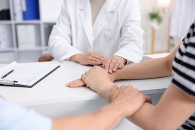 Photo of In vitro fertilization (IVF). Doctor encouraging couple during visit in reproductive clinic, closeup
