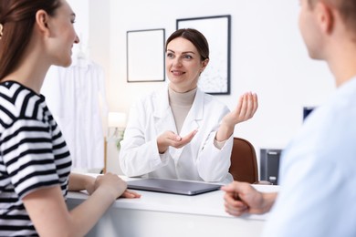 Photo of In vitro fertilization (IVF). Couple having appointment with doctor in reproductive clinic, selective focus