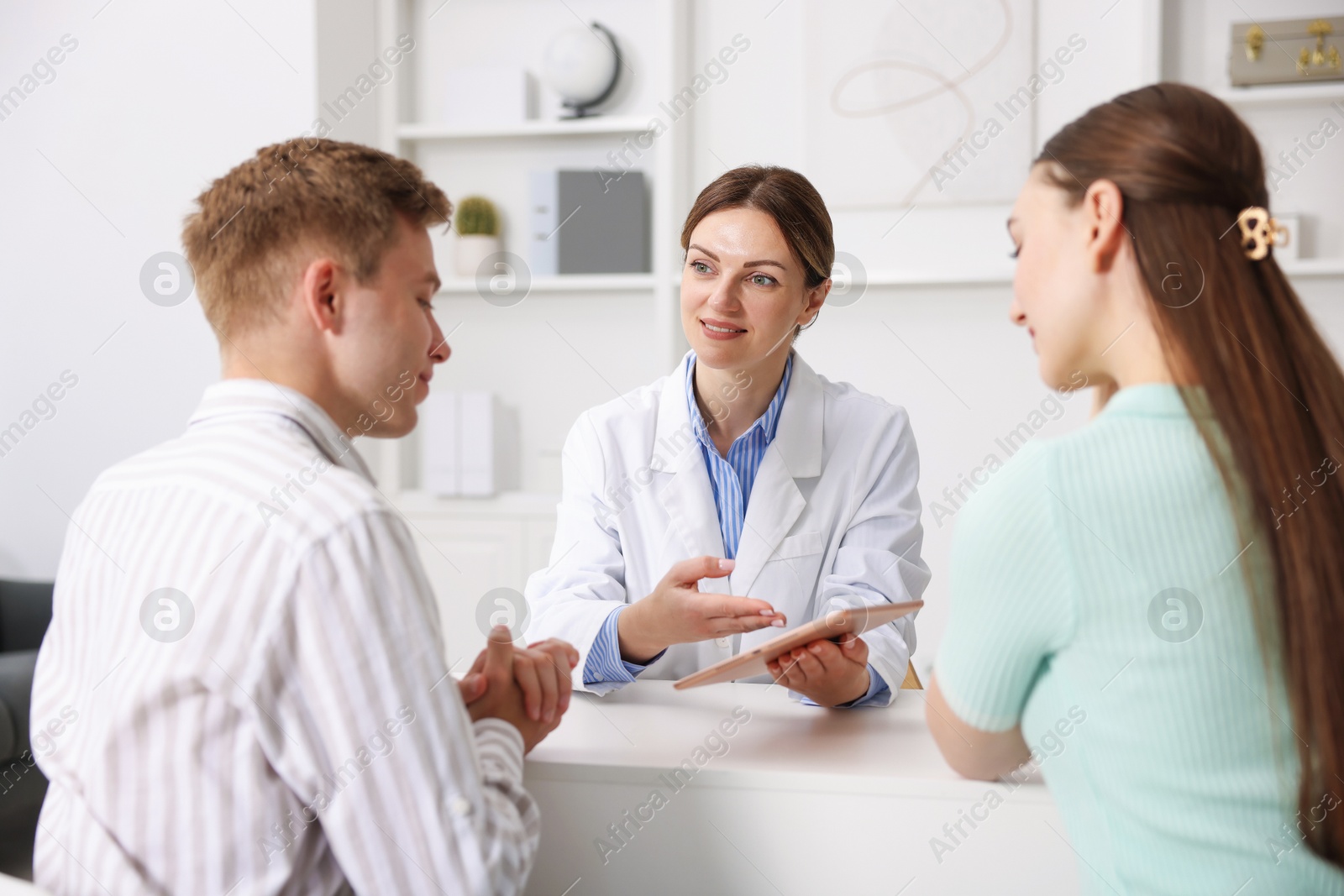 Photo of In vitro fertilization (IVF). Couple having appointment with doctor in reproductive clinic