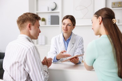 Photo of In vitro fertilization (IVF). Couple having appointment with doctor in reproductive clinic