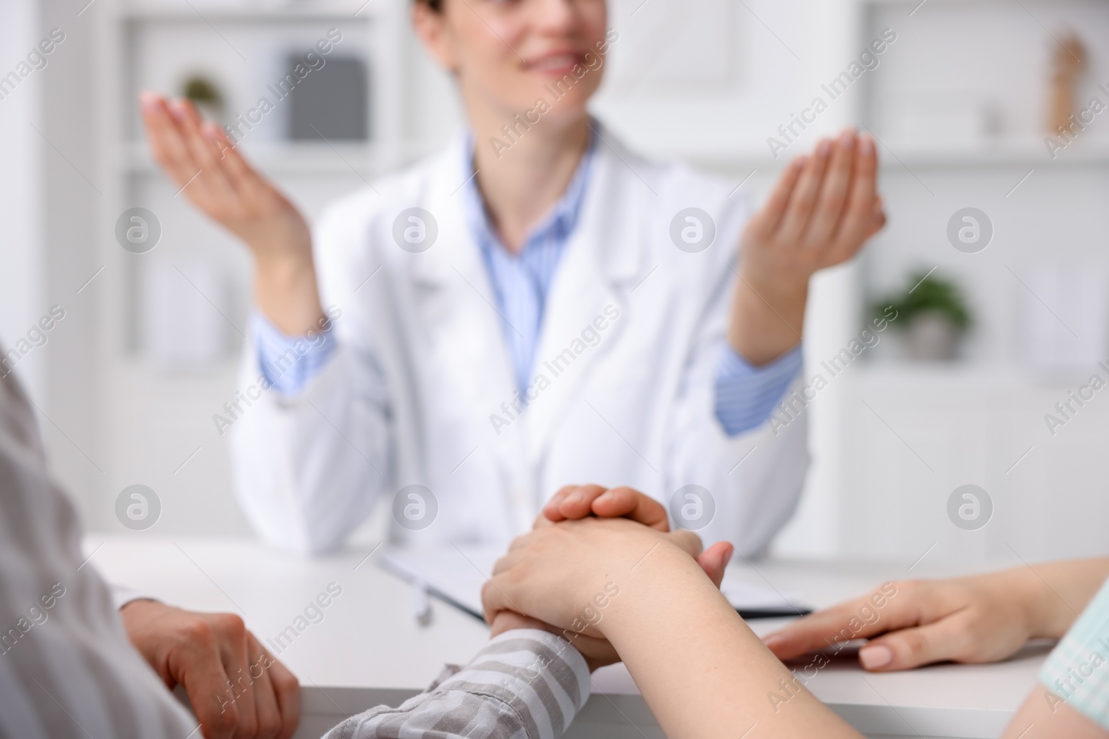 Photo of In vitro fertilization (IVF). Couple holding hands during appointment with doctor in reproductive clinic, closeup