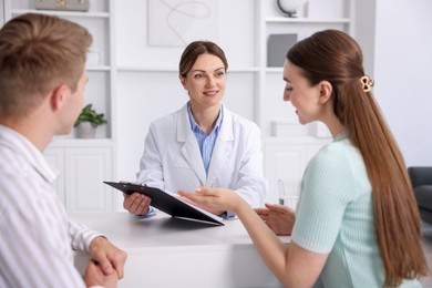 Photo of In vitro fertilization (IVF). Couple having appointment with doctor in reproductive clinic