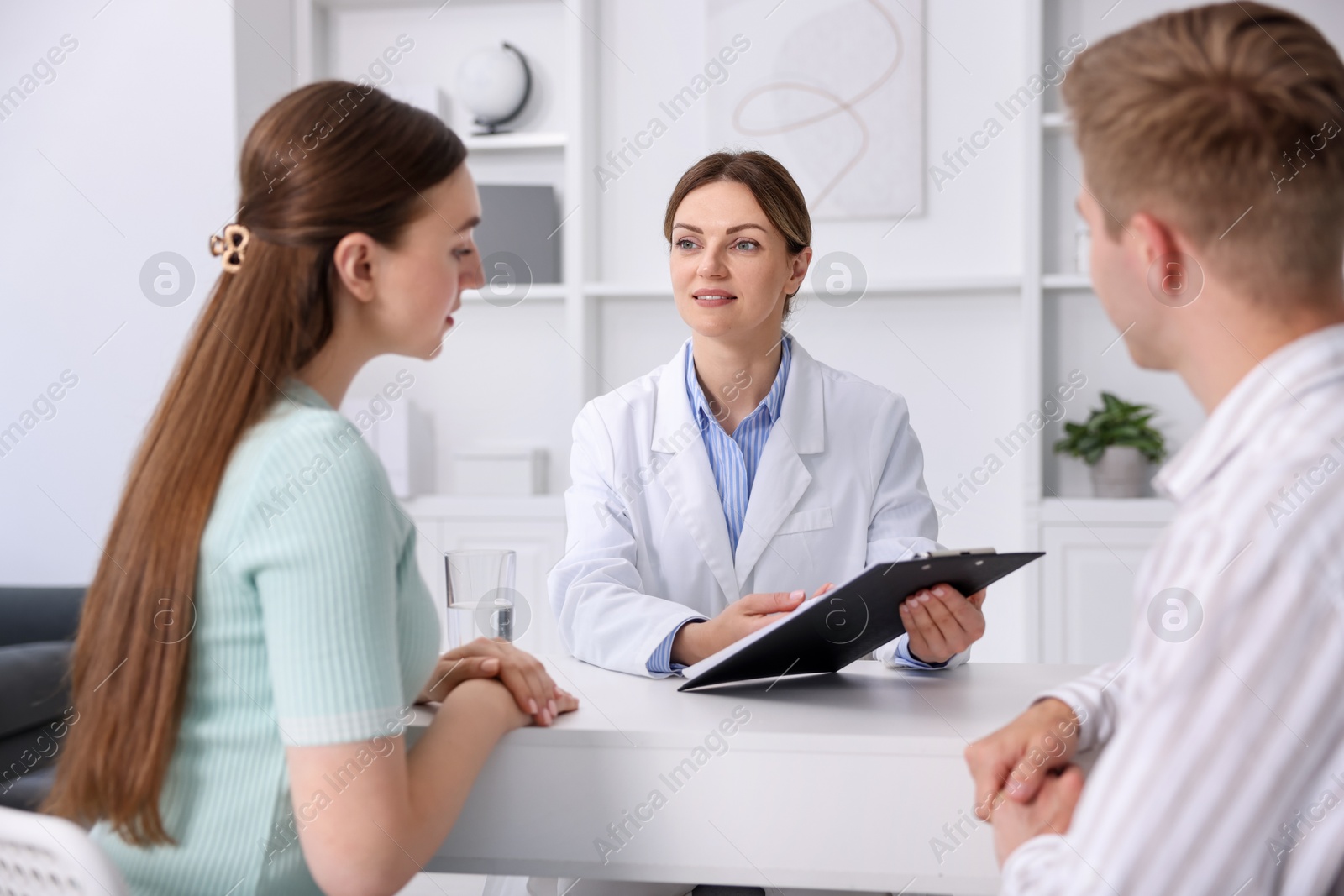 Photo of In vitro fertilization (IVF). Couple having appointment with doctor in reproductive clinic