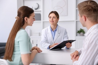 Photo of In vitro fertilization (IVF). Couple having appointment with doctor in reproductive clinic